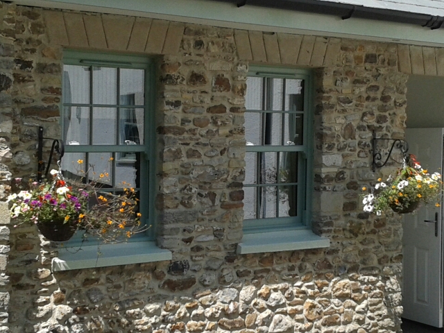 chartwell green vertical sliding windows in stone wall