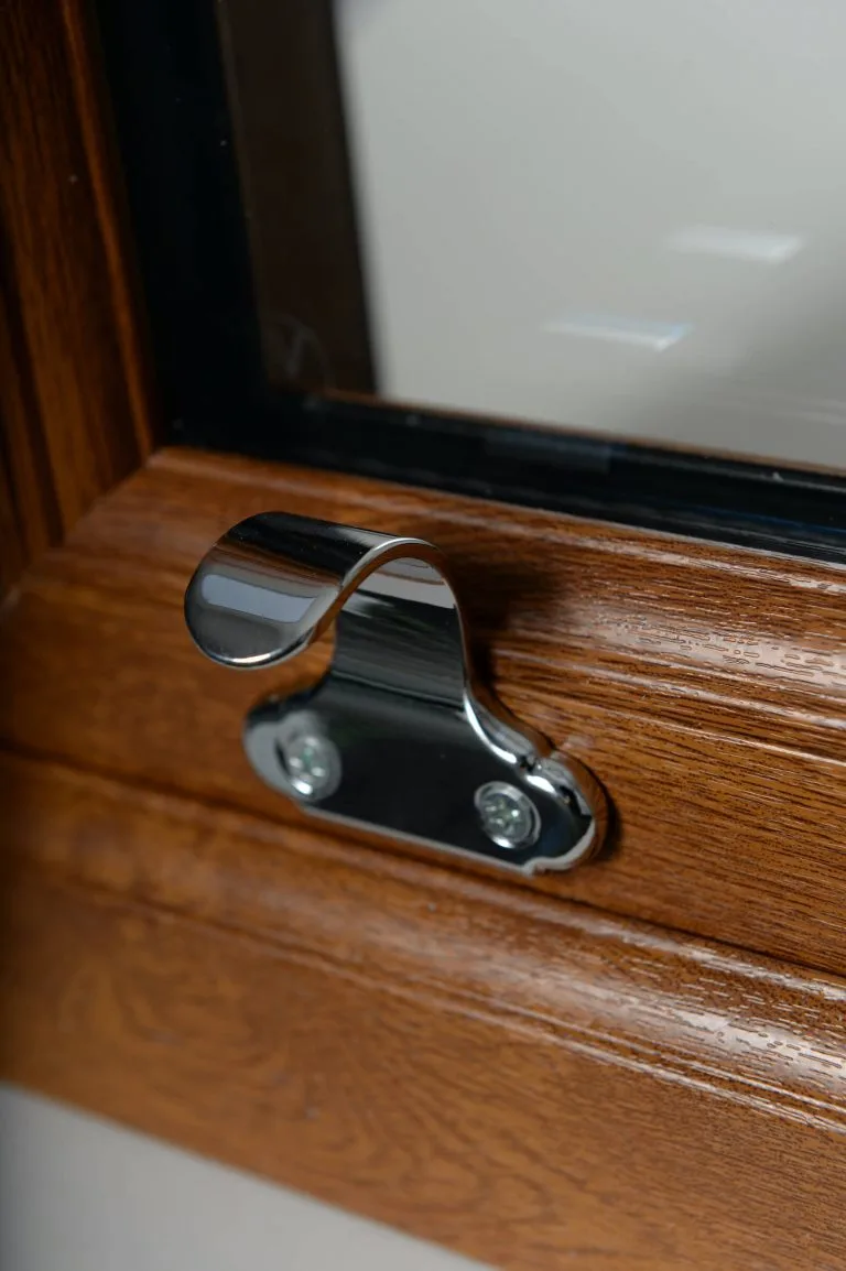 chrome vertical sliding window furniture on woodgrain frame