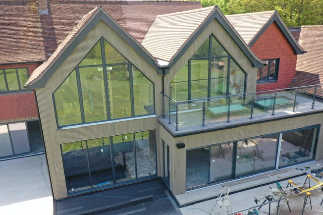 large grey aluminium picture windows in large house