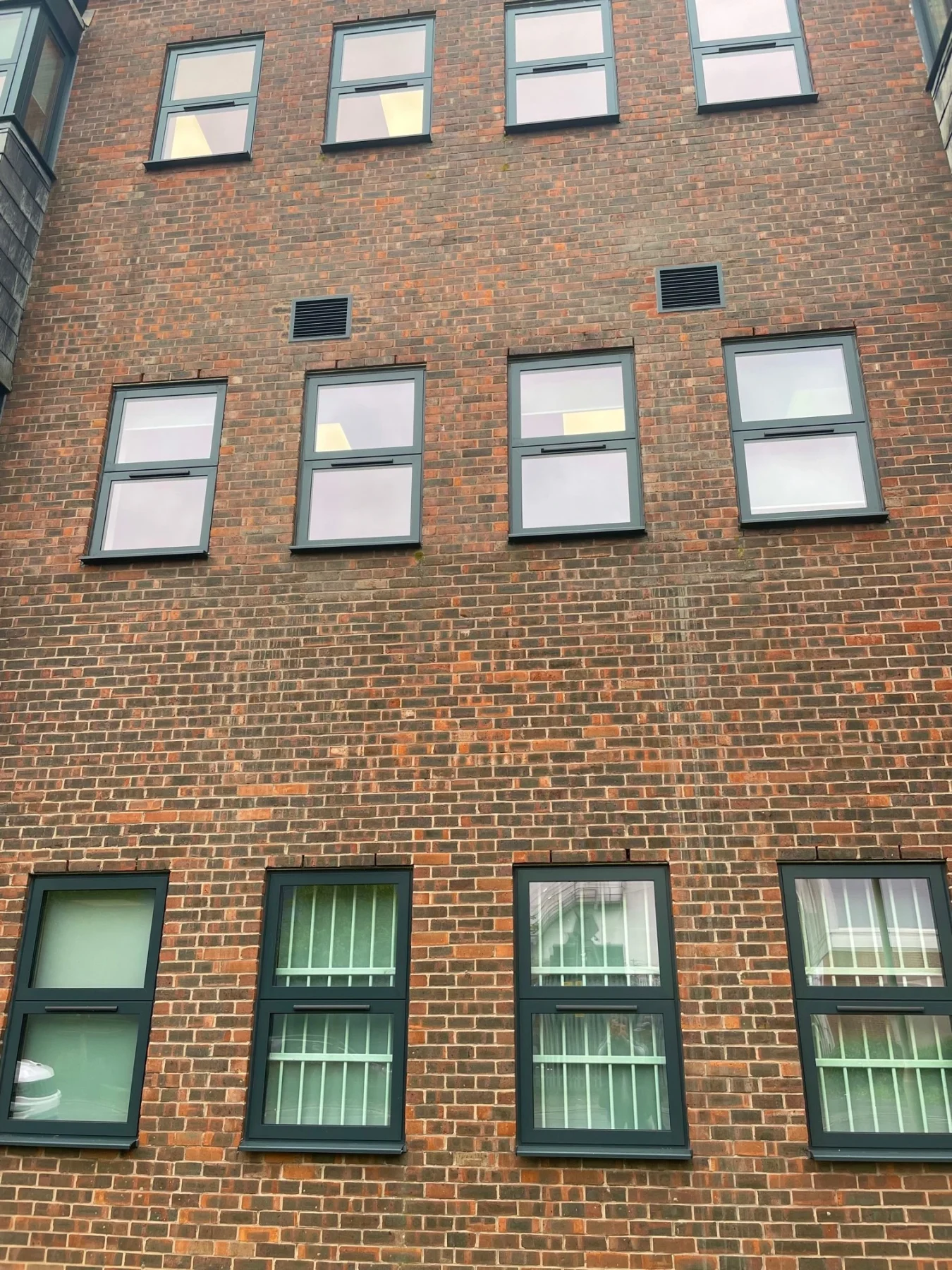 grey aluminium windows in brick wall