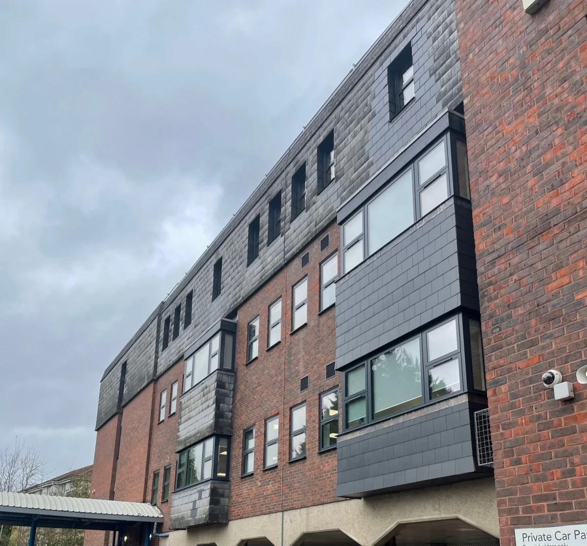 antracite grey aluminium bay windows in office block in hampshire