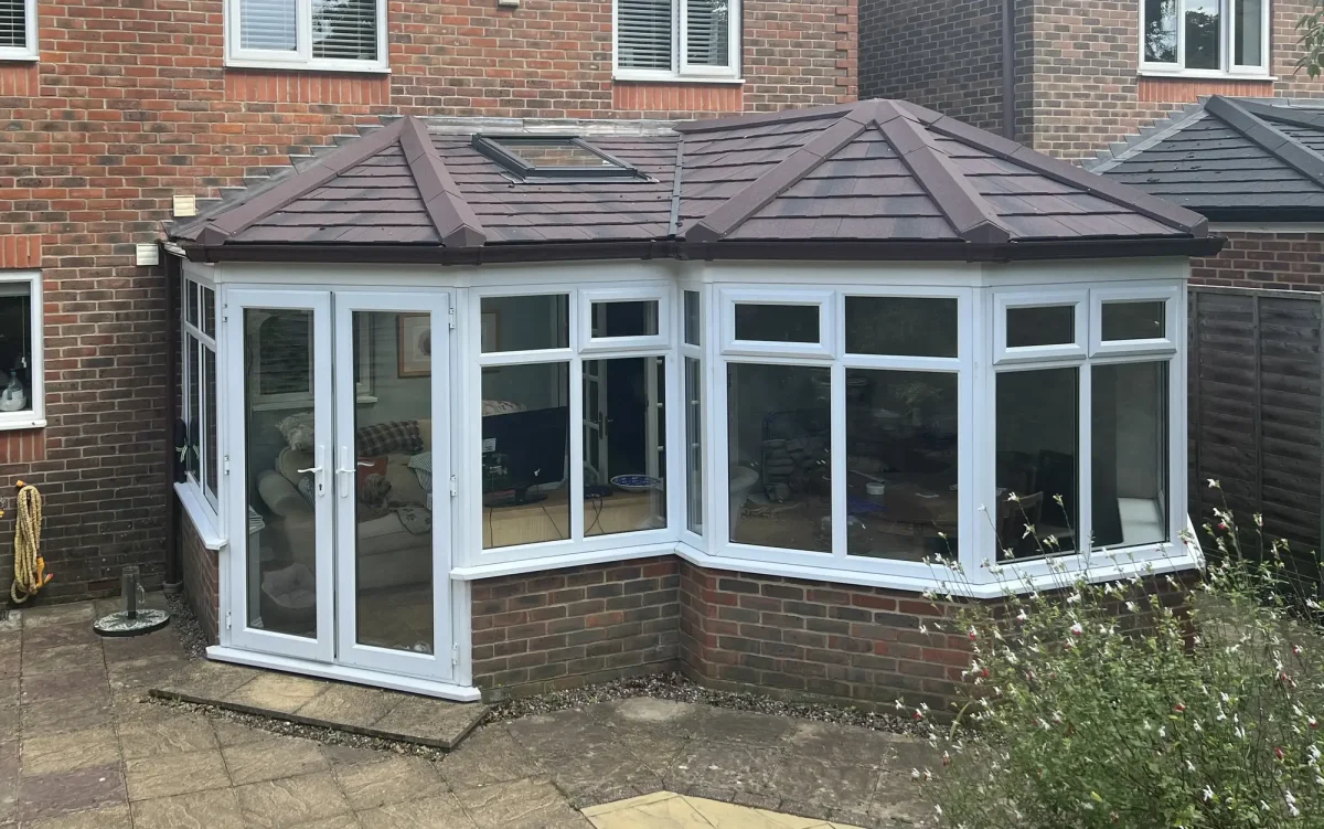 combination replacement conservatory roof with white french doors in hampshire