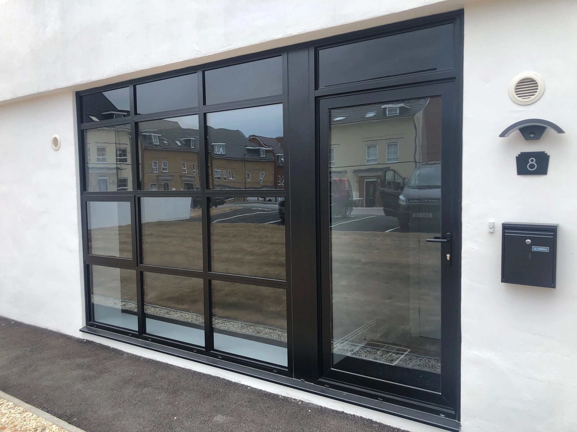 blck aluminium window in white rendered building