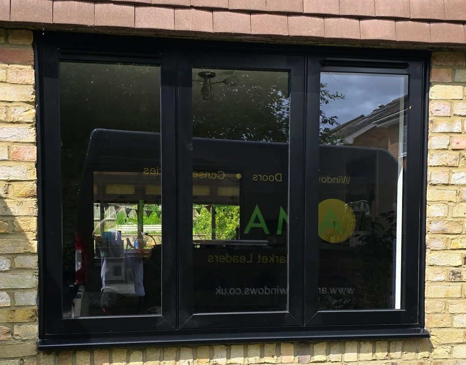 black upvc flush fit window in pale brickwork