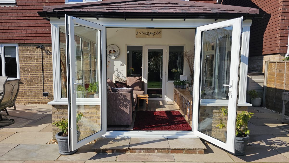 french doors open on solid roof garden room